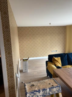 Bedroom interior with patterned wallpaper and painted walls