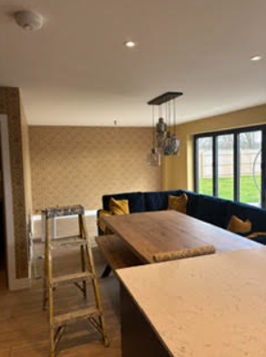 Interior room with yellow patterned wallpaper and black seating