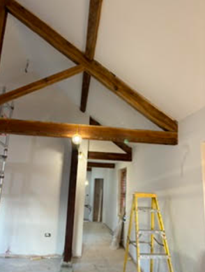 Interior room with exposed wooden beams during works